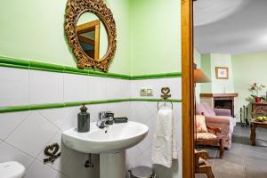 a bathroom with a sink and a mirror at Puente del Narcea 4 in Cibuyo +20 photos
