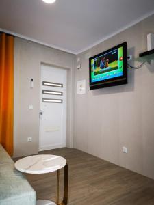a living room with a tv on a wall at Apartamento ms in Campo Maior