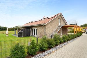 a house with a garden and a fence at Speicherhäuschen Maren in Geeste