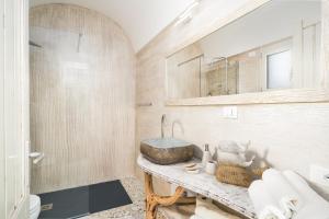 a bathroom with a sink and a mirror at Giojas125- Monolocale per 2 persone in Orosei