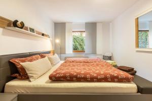 a bedroom with a large bed with orange sheets at Ferienwohnung Klein und Fein in Edertal