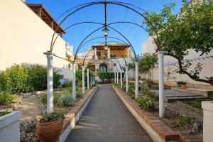 a walkway through a garden with an arbor at Villa Merina in Vieste