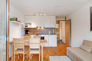 a kitchen and dining room with a table and chairs at Ferienwohnung Maier - Fontanella in Fontanella