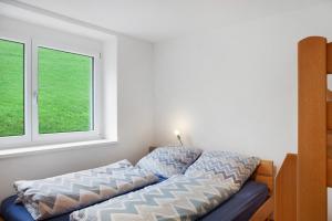 a bed in a room with a window at Ferienwohnung Maier - Fontanella in Fontanella