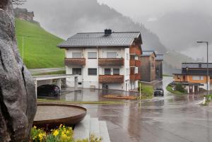a house on a street in the rain at Ferienwohnung Maier - Fontanella in Fontanella