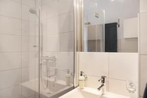 a bathroom with a shower and a sink at Ferienwohnung Maier - Fontanella in Fontanella +30 photos