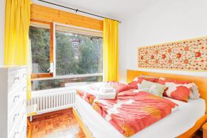 a bedroom with a large bed and a window at Masella in La Masella