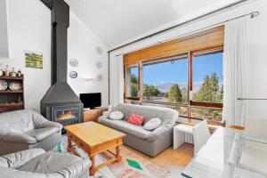 a living room with a couch and a fireplace at Masella in La Masella