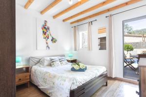 a bedroom with a bed and a balcony at Can Darder in Sóller