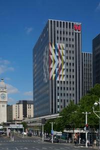 a tall building with a flag on the side of it at citizenM Paris Gare de Lyon in Paris +25 photos