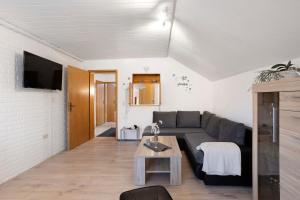 a living room with a couch and a table at Sara´s Ferienwohnung in Plettenberg