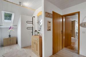 a bathroom with a hallway with a sink and a mirror at Sara´s Ferienwohnung in Plettenberg +23 photos