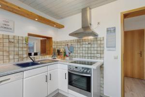 a kitchen with a sink and a stove top oven at Sara´s Ferienwohnung in Plettenberg