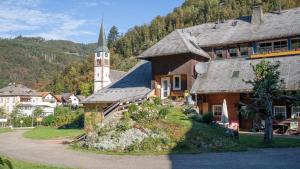 a large building with a church and a tower at Schwarzwaldferienwohnung Oberle in Todtnau