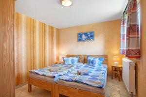 a bedroom with a large bed with blue pillows at Ferienhaus Struve in Trent