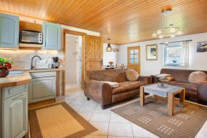a living room with two couches and a kitchen at Ferienhaus Struve in Trent