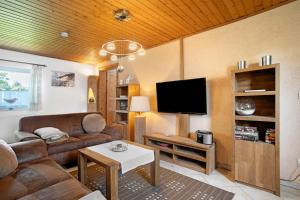 a living room with a couch and a tv at Ferienhaus Struve in Trent
