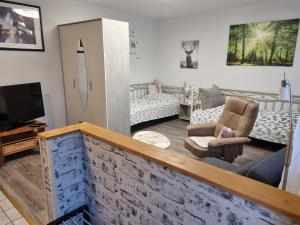 a living room with a couch and a tv at Ferienwohnung Kuckuck in Ohlsbach