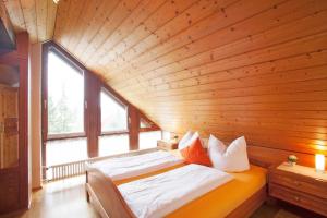a bed in a room with a wooden ceiling at Ferienwohnungen Merkle in Wasserburg