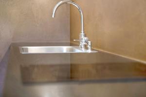 a kitchen sink with a faucet on top of it at Teutenhofer Kastanie in Feldthurns +14 photos