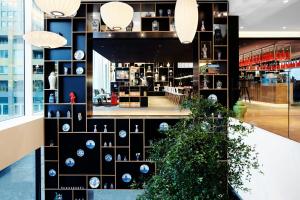 a store with blue and white clocks on a black wall at citizenM Rotterdam in Rotterdam