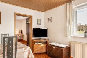 a living room with a flat screen tv on a stand at Möblierte Wohnung Ferienwohnung in Aicha vorm Wald