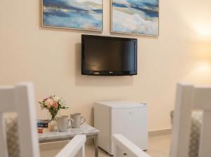 a living room with a tv on the wall at Orange City Center in Tirana