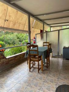 a patio with a table and chairs on a porch at 4 Seasons apartments in Himare