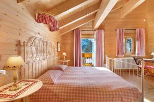 a bedroom with a bed in a wooden room at Chalet de La Poya in Valtournenche