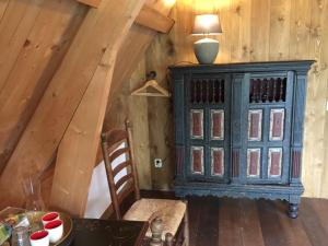 a blue cabinet in a room with a table at Hylper Huis in Hindeloopen