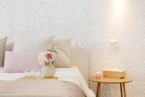 a bedroom with a bed with a vase with flowers at Martimar Candelaria in Candelaria +31 photos