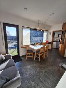a kitchen and dining room with a table and chairs at Ferienhaus Höhenflug in Attendorn