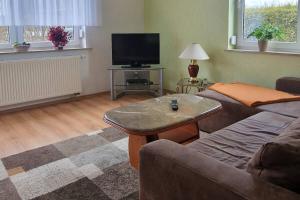 a living room with a couch and a coffee table at Apartment Kleine Auszeit in Wiendorf