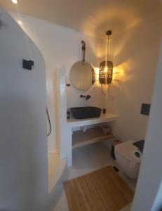 a bathroom with a sink and a toilet at Batsi view house in Andros +14 photos