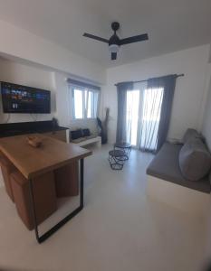 a living room with a couch and a table at Batsi view house in Andros