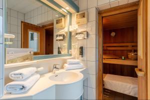 a bathroom with a sink and a mirror at Taun Hövt in Groß Zicker +129 photos
