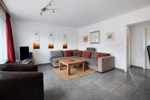 a living room with a couch and a table at Sylt Ferienwohnung 1 Westerland in Westerland