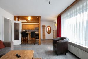 a living room with a couch and a table at Sylt Ferienwohnung 1 Westerland in Westerland
