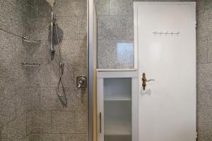 a bathroom with a shower with a glass door at Sylt Ferienwohnung 1 Westerland in Westerland +18 photos
