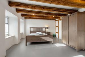 a bedroom with a bed and a desk in a room at Villa Arena in Geisingen