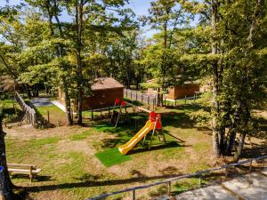 a playground with a slide in a park at Gite 4 de l'Orée du Bois in Thenon