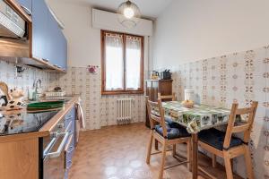 a kitchen with a table and chairs in a room at Depandance Resort in Borgo San Lorenzo +12 photos