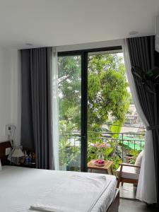 a bedroom with a bed and a large window at Khánh Vy Homestay in Thôn Lại Thê +19 photos