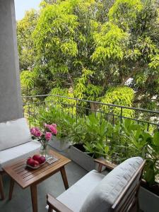 a balcony with a table and chairs and trees at Khánh Vy Homestay in Thôn Lại Thê