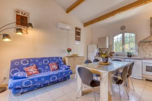 a living room with a blue couch and a table at Madrague St Vincent Apt B in Le Grau-dʼAgde