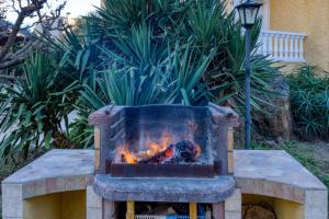 a fire pit in a yard with a fire in it at Madrague St Vincent Apt B in Le Grau-dʼAgde