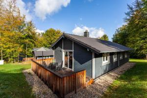 a small house with a deck in the yard at Ferienhaus 14 in Bad Arolsen