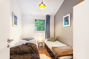 two beds in a room with a window at Ferienhaus 14 in Bad Arolsen