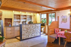 an open kitchen with a brick wall in a house at Birkenhof - Wohnung Bichel in Sluderno