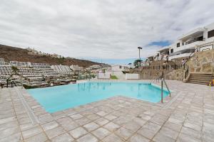 a large blue swimming pool in a building at Alohe Puertorico View in Puerto Rico de Gran Canaria
